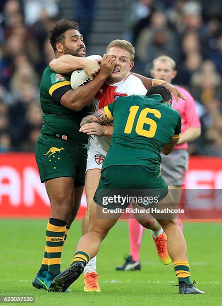 George Burgess of England is tackled by Tyson Frizell and Sam Thaiday of Australia during the Four Nations match between the England and Australian...