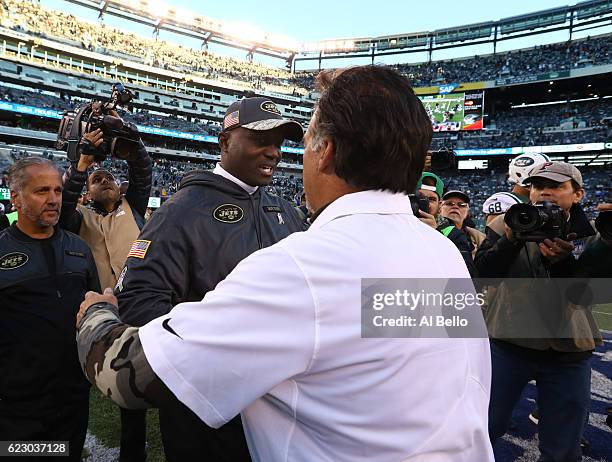 Head coach Todd Bowles of the New York Jets and head coach Jeff Fisher of the Los Angeles Rams embrace after the Rams won 9-6 at MetLife Stadium on...