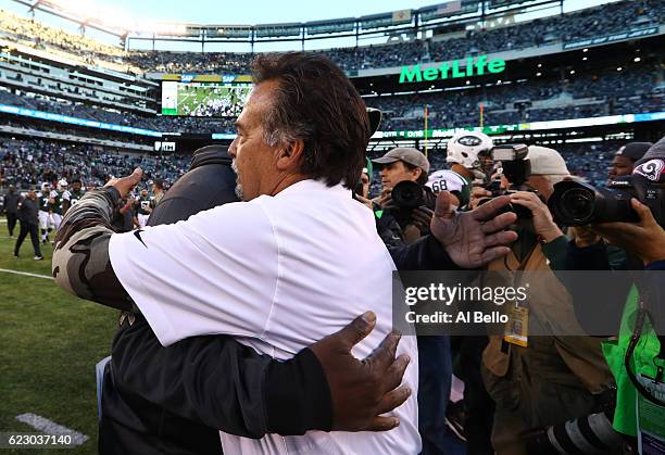 Head coach Todd Bowles of the New York Jets and head coach Jeff Fisher of the Los Angeles Rams embrace after the Rams won 9-6 at MetLife Stadium on...