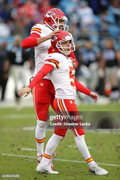 Cairo Santos celebrates after kicking a game winning field goal with teammate James Winchester of the Kansas City Chiefs to defeat the Carolina...