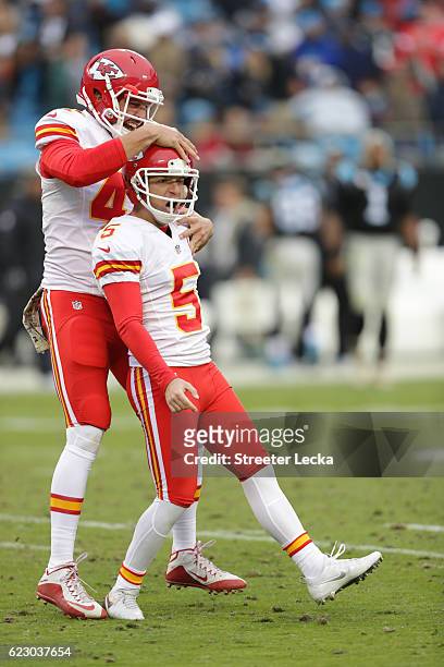Cairo Santos celebrates after kicking a game winning field goal with teammate James Winchester of the Kansas City Chiefs to defeat the Carolina...