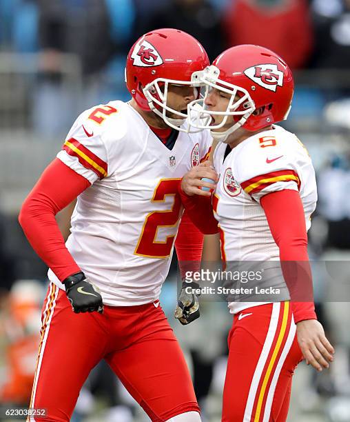 Cairo Santos celebrates after kicking a game winning field goal with teammate Dustin Colquitt of the Kansas City Chiefs to defeat the Carolina...