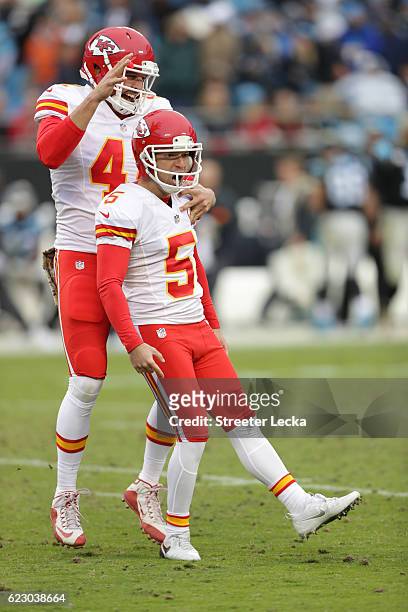 Cairo Santos celebrates after kicking a game winning field goal with teammate James Winchester of the Kansas City Chiefs to defeat the Carolina...