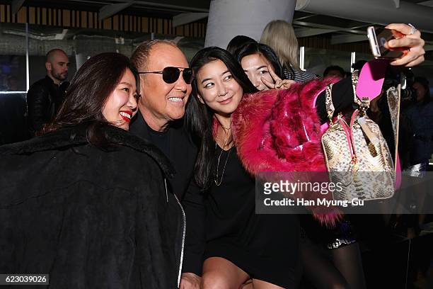Fans and Michael Kors pose for a selfie during the Michael Kors Cheongdam Flagship Store Opening Cocktail Party on November 12, 2016 in Seoul, South...