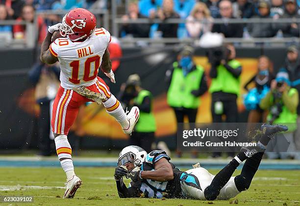 Tyreek Hill of the Kansas City Chiefs spins out of a tackle by Robert McClain of the Carolina Panthers during the game at Bank of America Stadium on...