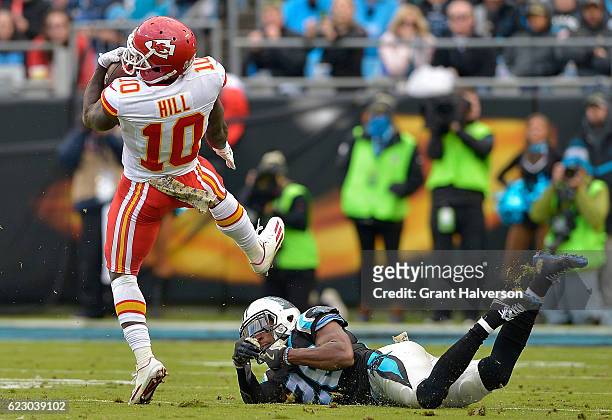 Tyreek Hill of the Kansas City Chiefs spins out of a tackle by Robert McClain of the Carolina Panthers during the game at Bank of America Stadium on...