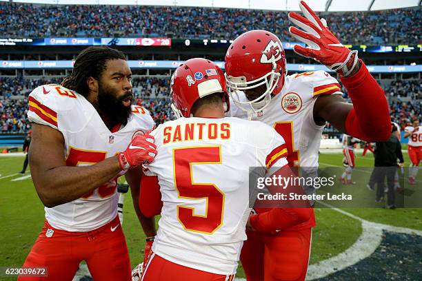 Ramik Wilson and Demetrius Harris congratulate teammate Cairo Santos of the Kansas City Chiefs on his game winning field goal after their game...