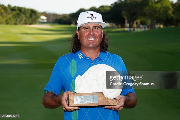 Pat Perez of the United States poses with the 2016 Champions Trophy after winning the OHL Classic at Mayakoba on November 13, 2016 in Playa del...