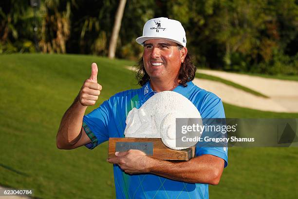 Pat Perez of the United States poses with the 2016 Champions Trophy after winning the OHL Classic at Mayakoba on November 13, 2016 in Playa del...