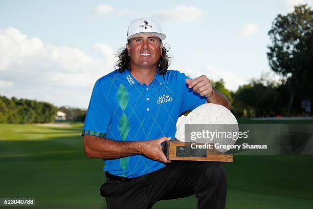 Pat Perez of the United States poses with the 2016 Champions Trophy after winning the OHL Classic at Mayakoba on November 13, 2016 in Playa del...