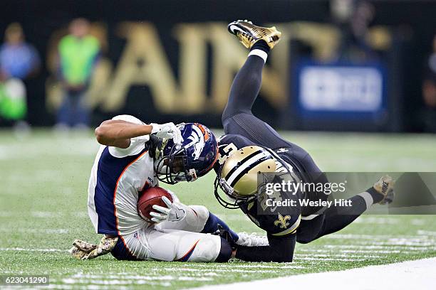 Jordan Norwood of the Denver Broncos is tackled by Sterling Moore of the New Orleans Saints at Mercedes-Benz Superdome on November 13, 2016 in New...