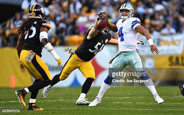 Anthony Chickillo of the Pittsburgh Steelers strips the ball away from quarterback Dak Prescott of the Dallas Cowboys for a fumble in the first...