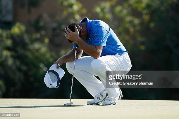 Gary Woodland of the United States reacts to his round prior to putting for par on the 17th green during the final round of the OHL Classic at...