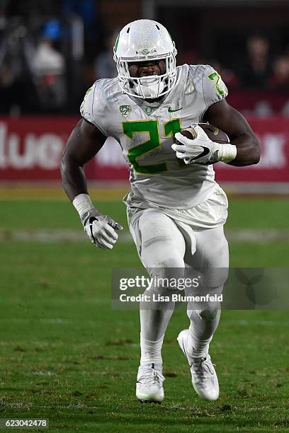 Royce Freeman of the Oregon Ducks advances the ball during the game against the USC Trojans defense at Los Angeles Memorial Coliseum on November 5,...