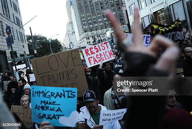 Thousands of anti-Donald Trump protesters, including many pro-immigrant groups, hold a demonstration along 5th Avenue as New Yorkers react to the...