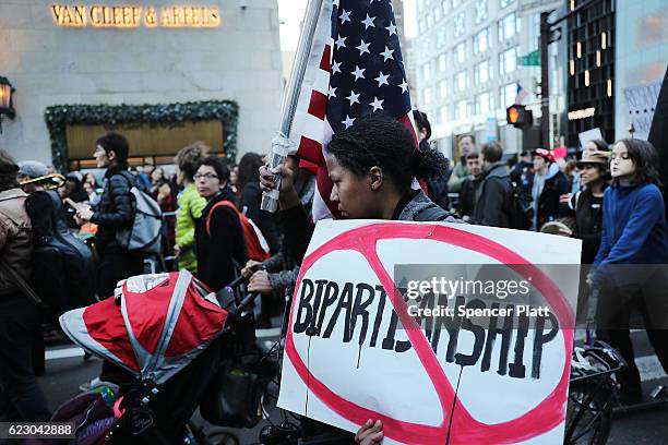 Thousands of anti-Donald Trump protesters, including many pro-immigrant groups, hold a demonstration along 5th Avenue as New Yorkers react to the...