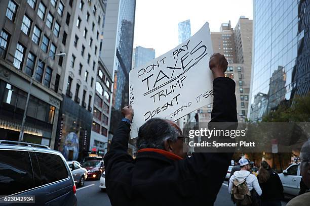 Thousands of anti-Donald Trump protesters, including many pro-immigrant groups, hold a demonstration along 5th Avenue as New Yorkers react to the...