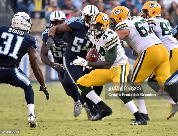 James Starks of the Green Bay Packers rushes against Kevin Byard of the Tennessee Titans during the second half at Nissan Stadium on November 13,...