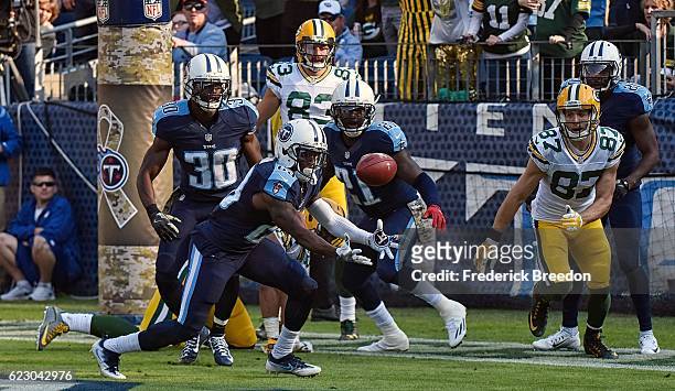 Rashad Johnson of the Tennessee Titans catches an interecption from a hail mary pass during the first half of a game against the Green Bay Packers at...