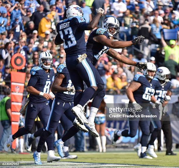 Tajae Sharpe of the Tennessee Titans congratulates teammate Kendall Wright on scoring a touchdown against the Green Bay Packers during the first half...