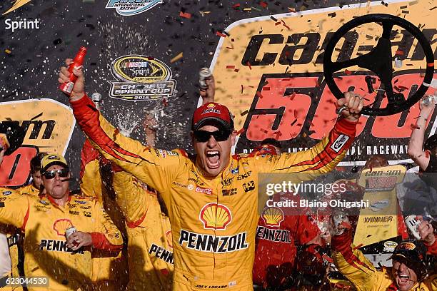 Joey Logano, driver of the Shell Pennzoil Ford, celebrates in Victory Lane after winning the NASCAR Sprint Cup Series Can-Am 500 at Phoenix...