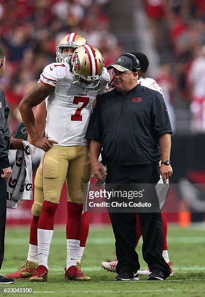 Head coach Chip Kelly of the San Francisco 49ers talks with quarterback Colin Kaepernick during the second quarter of the NFL football game against...