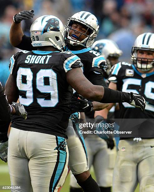 Carolina Panthers defensive tackle Kawann Short, left, is congratulated by cornerback Leonard Johnson, center, after Short sacked Kansas City Chiefs...