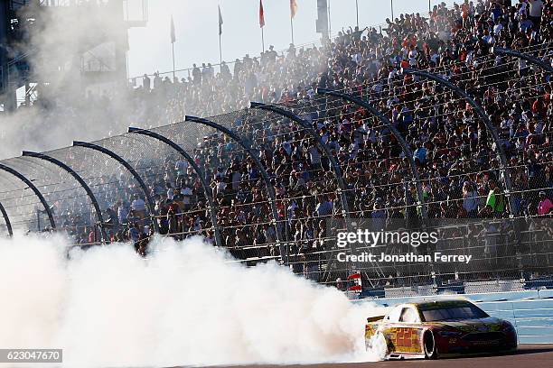 Joey Logano, driver of the Shell Pennzoil Ford, celebrates with a burnout after winning the NASCAR Sprint Cup Series Can-Am 500 at Phoenix...