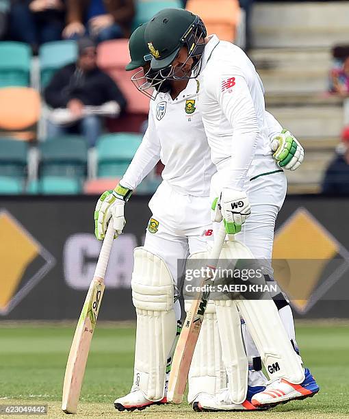 South Africa's batsman Quinton de Kock greets Temba Bavuma for his unbeaten 50-runs on the third day's play of the second Test cricket match between...