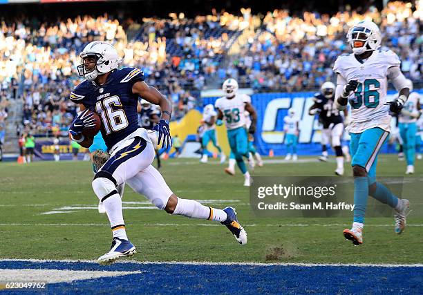 Tyrell Williams of the San Diego Chargers runs in a touchdown against the Miami Dolphins with Tony Lippett of the Miami Dolphins pursuing during the...