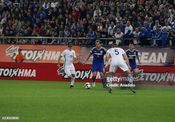 Kyriakos Papadopoulos of Greece in action against Senad Lulic of Bosnia and Herzegovina during the 2018 World Cup qualifying Group H football match...