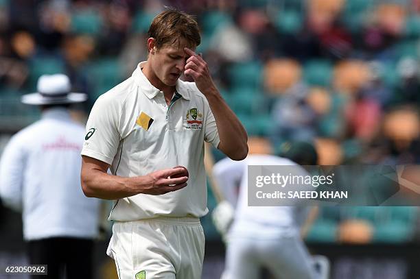 Australia's paceman Joe Mennie reaches to his bowling mark on the third day's play of the second Test cricket match between Australia and South...