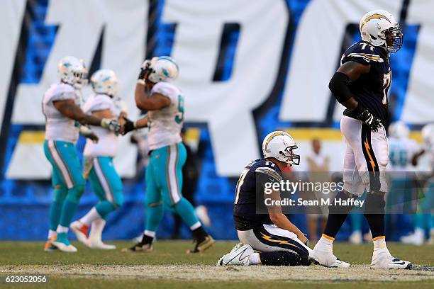 Philip Rivers and King Dunlap of the San Diego Chargers look on after an interception during the second half of a game against the Miami Dolphins at...