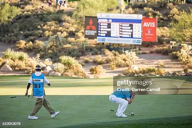 Bernhard Langer of Germany and caddie Terry Holt react to a missed eagle putt at the eighteenth hole during the final round of the Charles Schwab Cup...