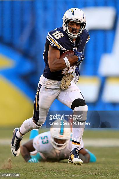 Tyrell Williams of the San Diego Chargers runs upfield on a pass play for a touchdown as Jelani Jenkins of the Miami Dolphins looks on during the...