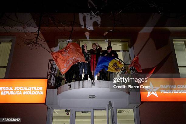 Supporters of Socialist Party candidate Igor Dodon celebrate after he was likely elected president of Moldova on November 13, 2016 in Chisinau,...