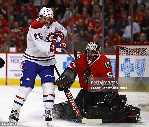 Andrew Shaw of the Montreal Canadiens tries to knock the puck down in front of Corey Crawford of the Chicago Blackhawks at the United Center on...