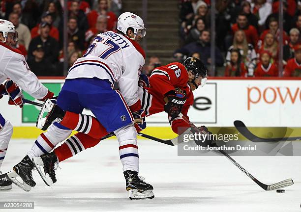 Patrick Kane of the Chicago Blackhawks is shoved to the ice by Max Pacioretty of the Montreal Canadiens as he shoots and scores a second period goal...