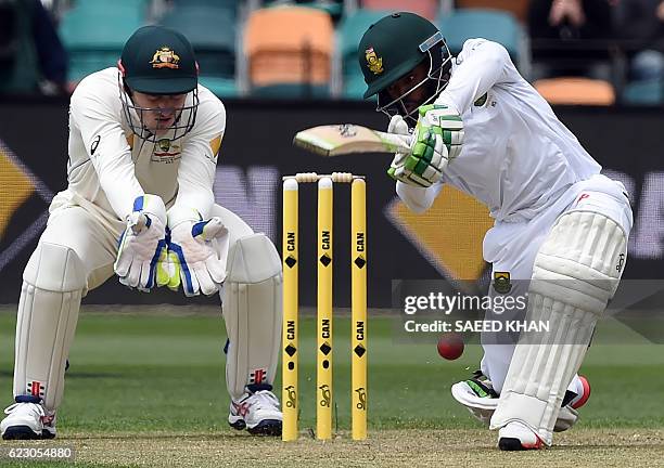 South Africa's batsman Temba Bavuma plays a shot as Australia's wicketkeeper Peter Nevill chase the ball on the third day's play of the second Test...