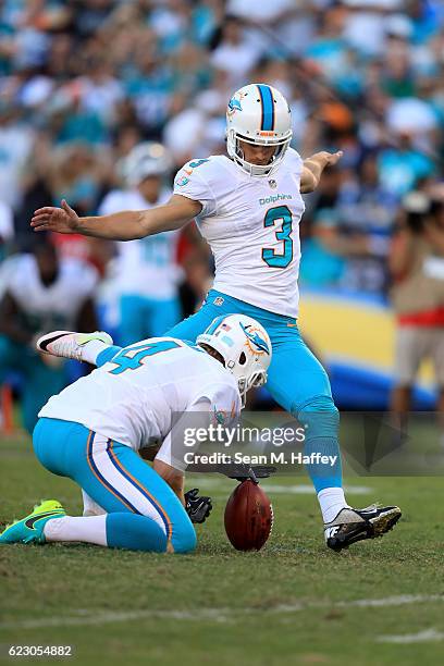 Matt Darr holds as Andrew Franks of the Miami Dolphins kicks a field goal during the second half of a game at Qualcomm Stadium on November 13, 2016...