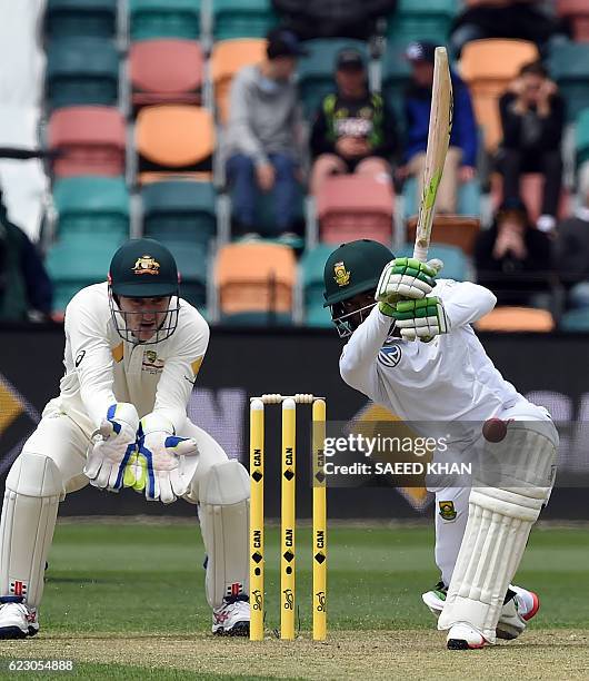 South Africa's batsman Temba Bavuma plays a shot as Australia's wicketkeeper Peter Nevill chase the ball on the third day's play of the second Test...
