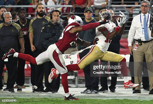 Quinton Patton of the San Francisco 49ers catches a pass while being defended by Justin Bethel of the Arizona Cardinals during the fourth quarter at...