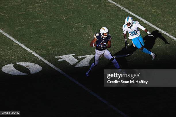 Tyrell Williams of the San Diego Chargers runs away from Tony Lippett of the Miami Dolphins during the second half of a game at Qualcomm Stadium on...