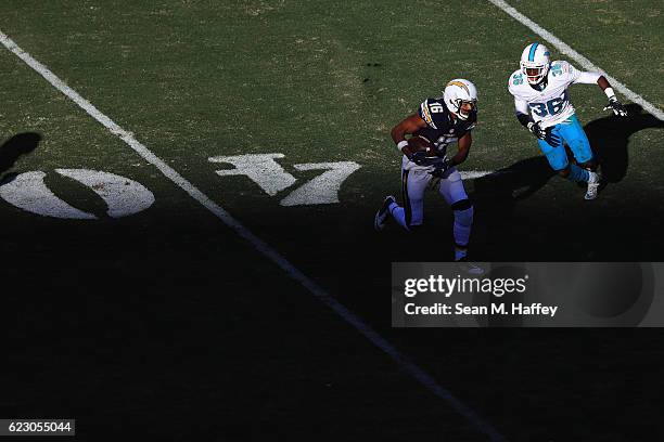 Tyrell Williams of the San Diego Chargers runs away from Tony Lippett of the Miami Dolphins during the second half of a game at Qualcomm Stadium on...