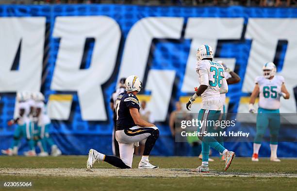 Philip Rivers of the San Diego Chargers looks on after throwing an interception while Tony Lippett of the Miami Dolphins looks on during the second...