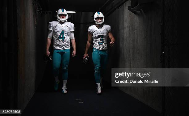 Matt Darr and Andrew Franks of the Miami Dolphins prepare to enter the field for a game against the San Diego Chargers Game at Qualcomm Stadium on...