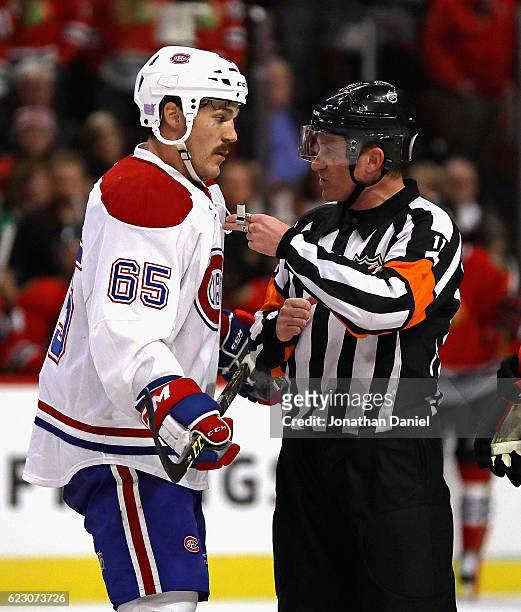 Andrew Shaw of the Montreal Canadiens jaws with referee Kelly Sutherland during a game against the Chicago Blackhawks at the United Center on...