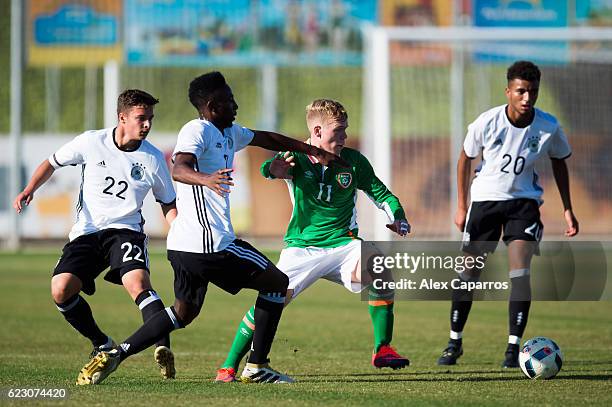 Anthony Scully of Ireland conducts the ball between Marvin-Lee Rittmuller , Gabriel Kyeremateng and Timothy Tillman of Germany during the U18...