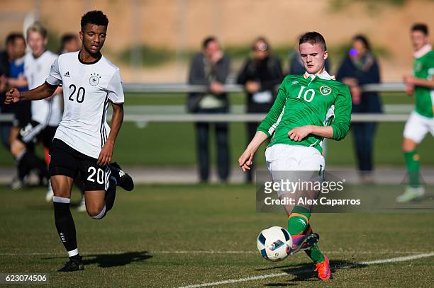 Thomas Byrne of Ireland plays the ball next to Timothy Tillman of Germany during the U18 international friendly match between Ireland and Germany on...