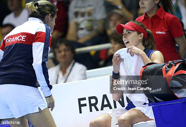 Alize Cornet of France talks to captain Amelie Mauresmo during the 2016 Fed Cup Final between France and Czech Republic at Rhenus Sport arena on...